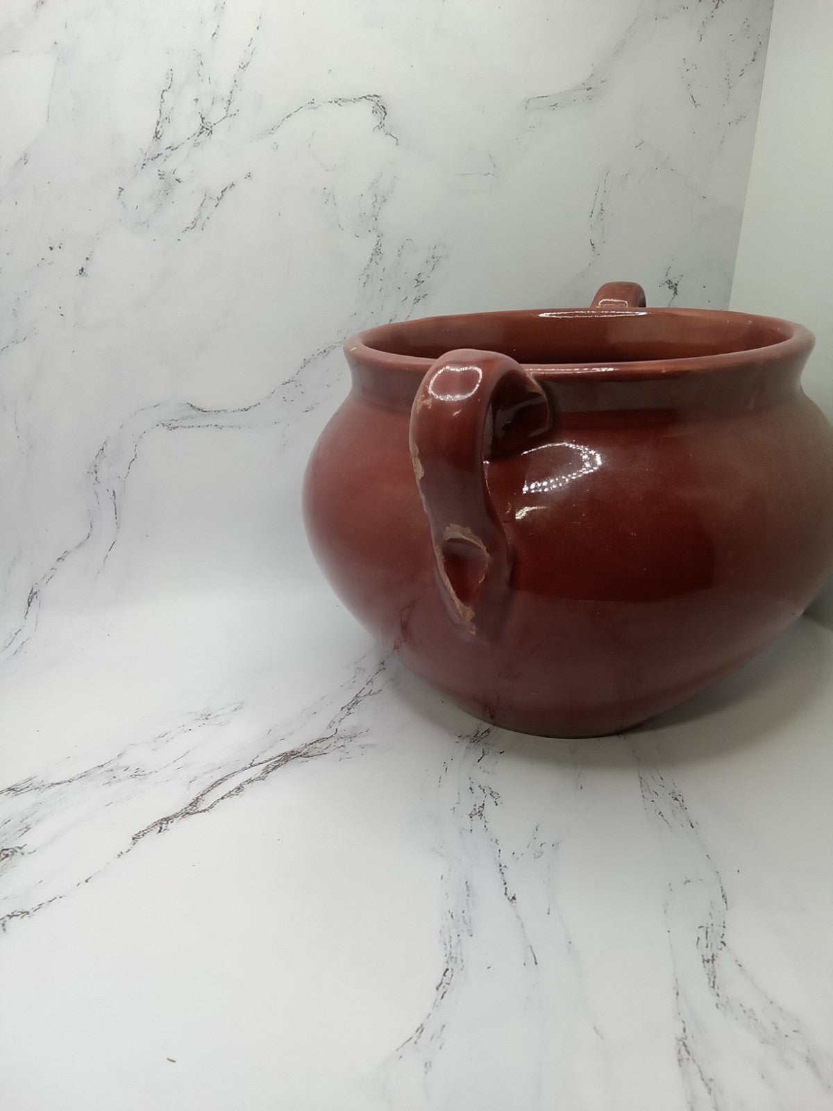 small, handled pot, likely a vintage bean pot possibly glazed Terracotta