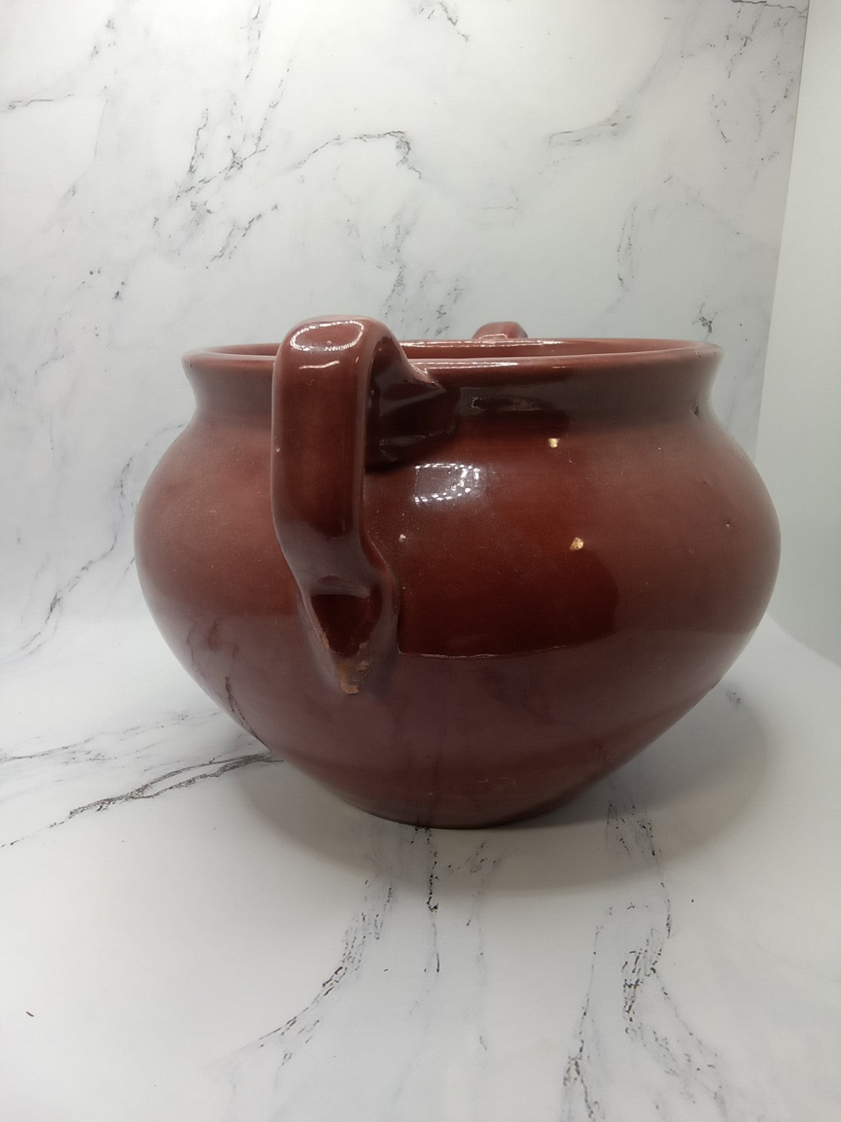small, handled pot, likely a vintage bean pot possibly glazed Terracotta