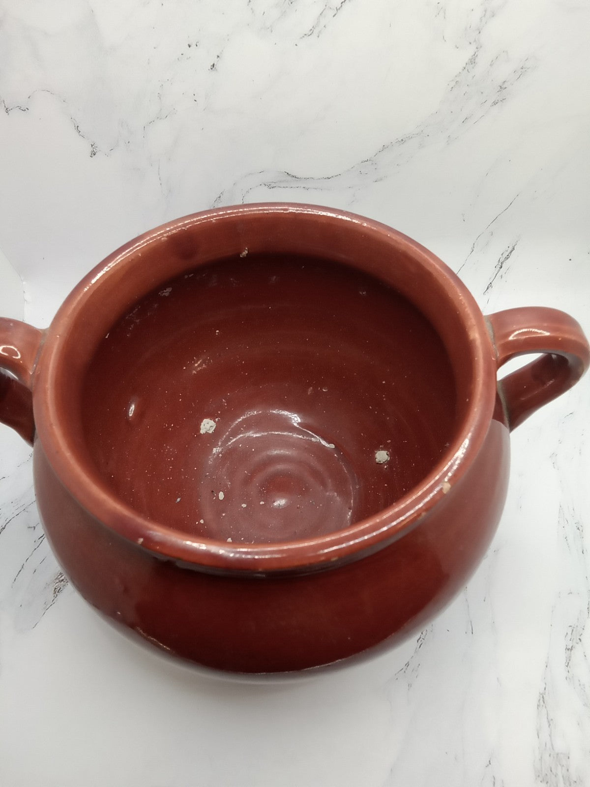 small, handled pot, likely a vintage bean pot  possibly glazed Terracotta